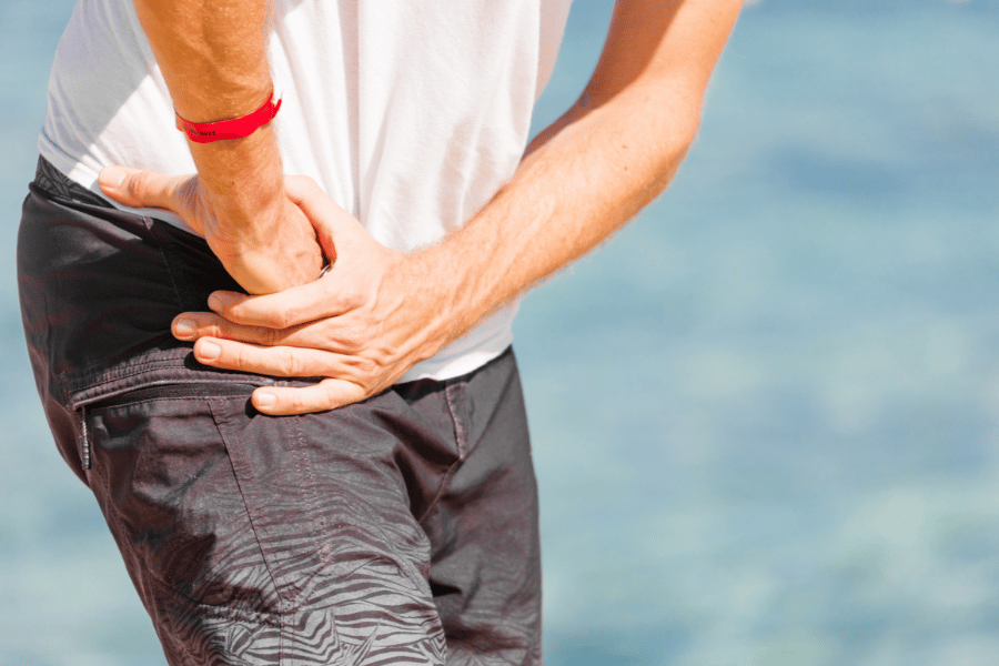 Young athletes wearing black sport wear have a right knee injury Bolečina na sprednji strani kolka